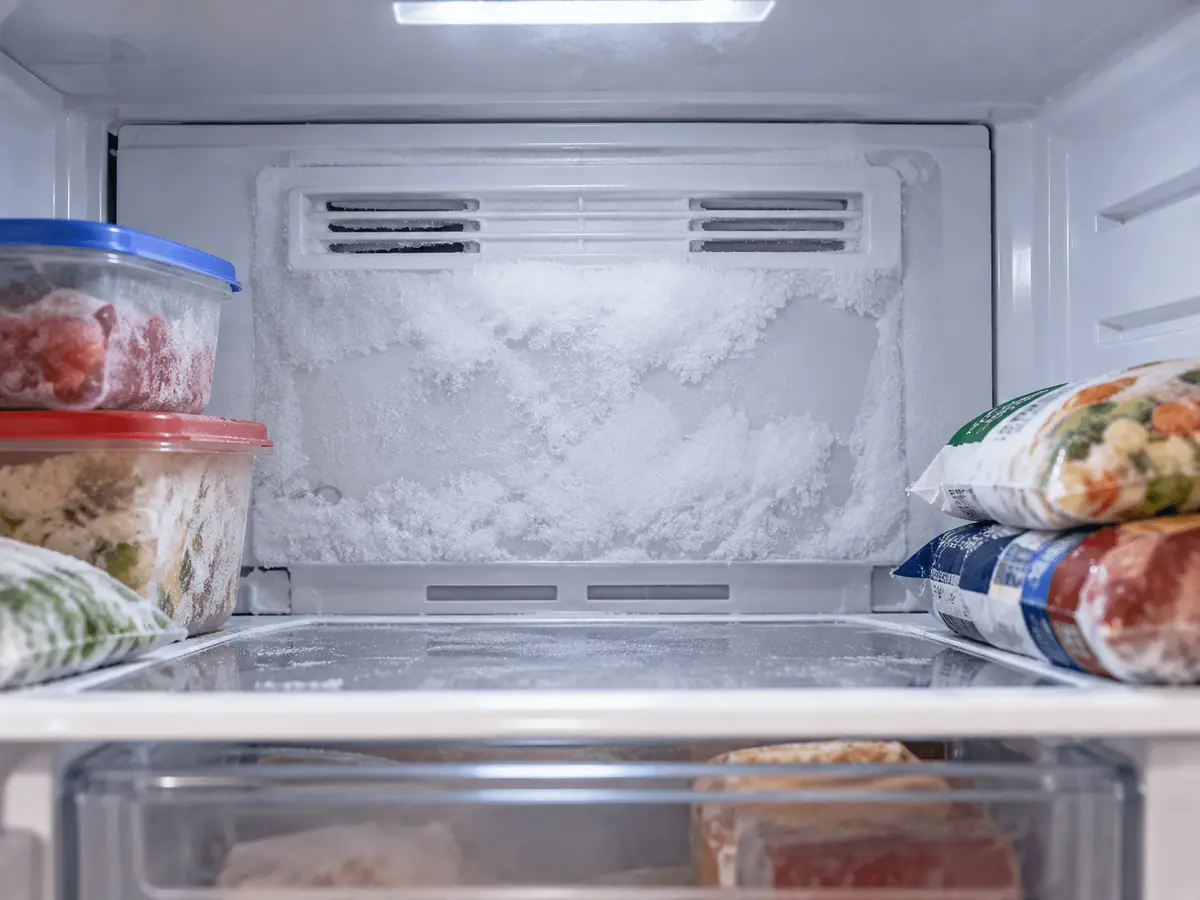 Frost buildup on the rear panel inside a household freezer