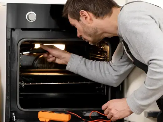 Technician testing an oven heating element