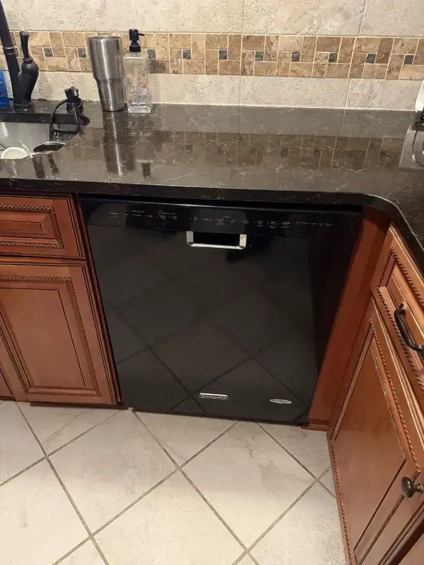 KitchenAid dishwasher repaired under a granite countertop