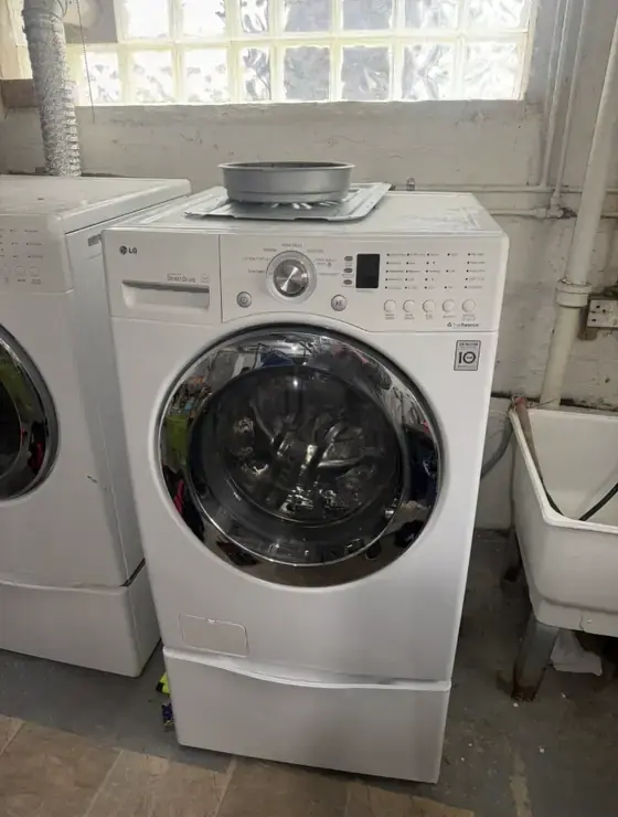 LG front-load washer on a pedestal