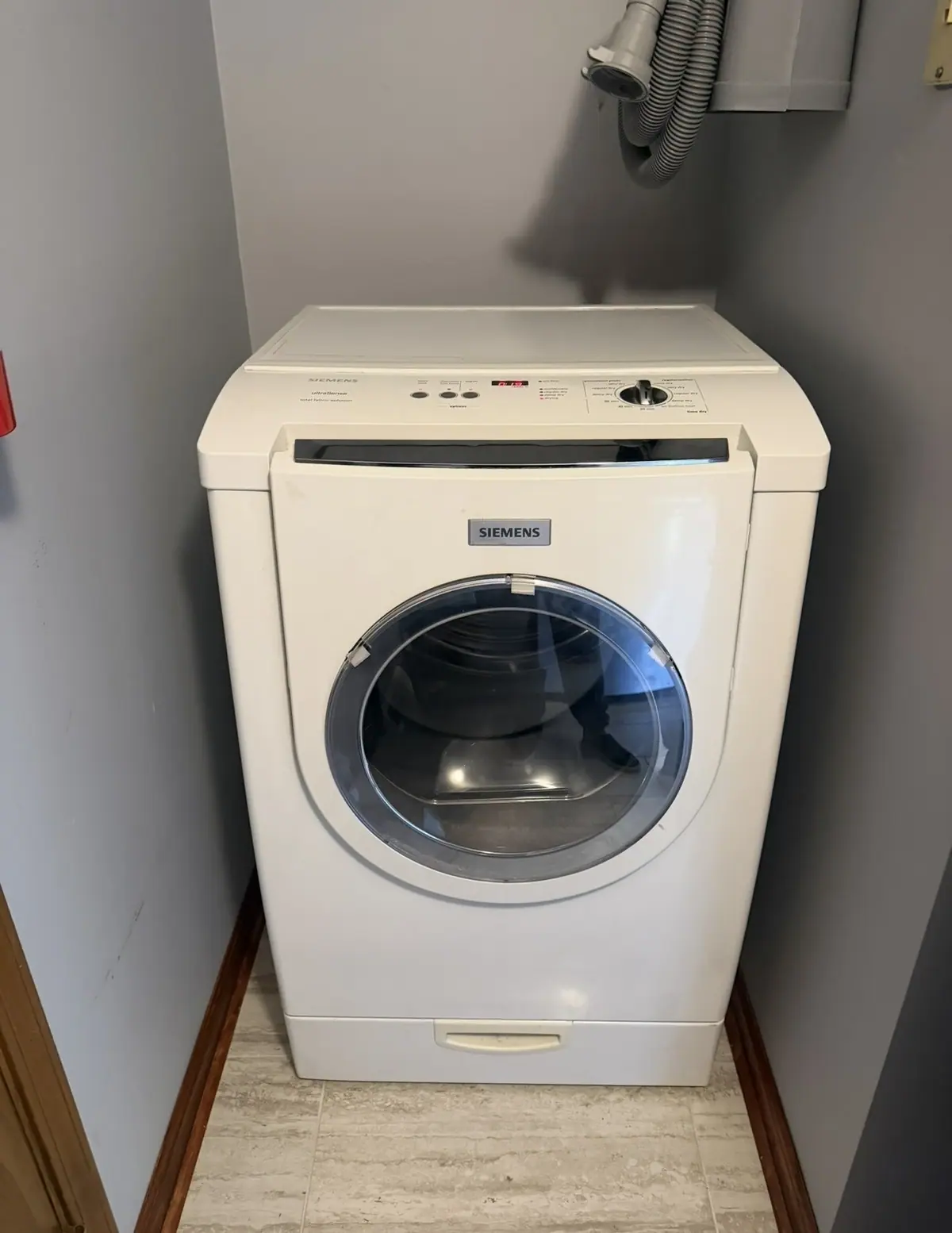 Siemens front-load washer in a laundry closet