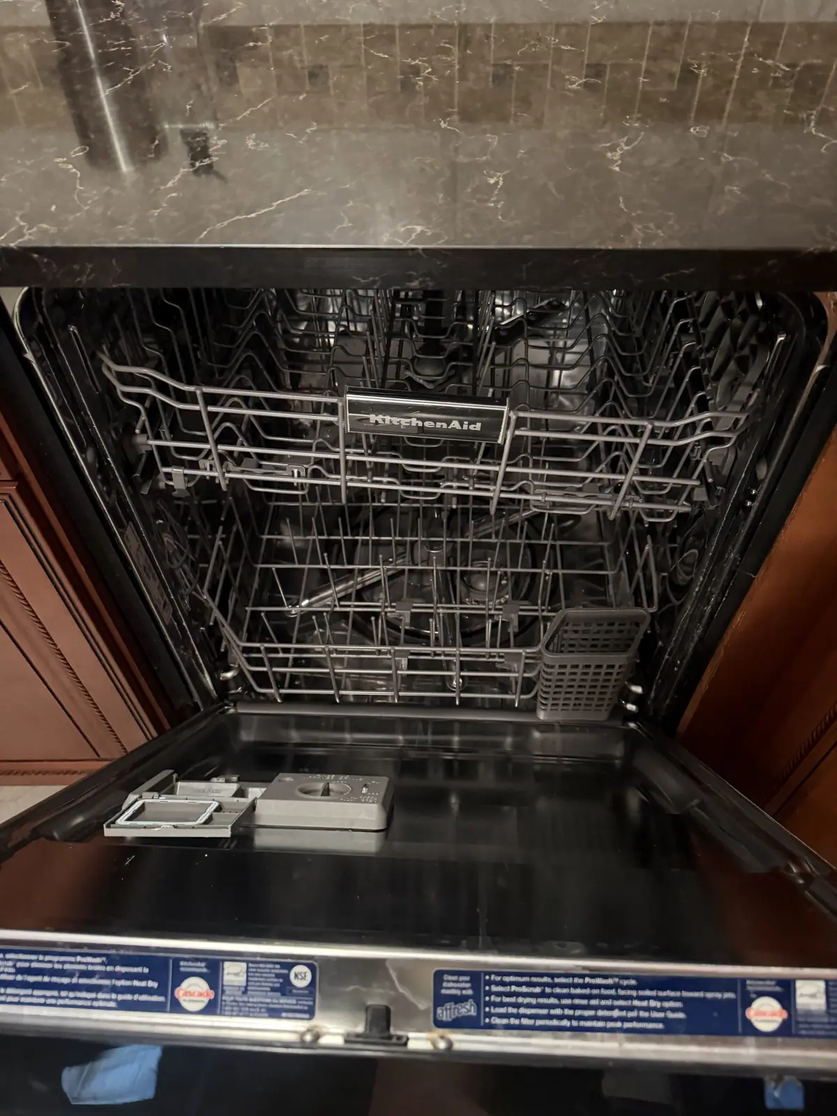 KitchenAid dishwasher with the door open and racks pulled out
